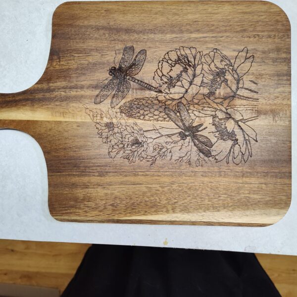 Acacia Engraved Serving/Charcuterie Board that is engraved with flowers and dragonflies